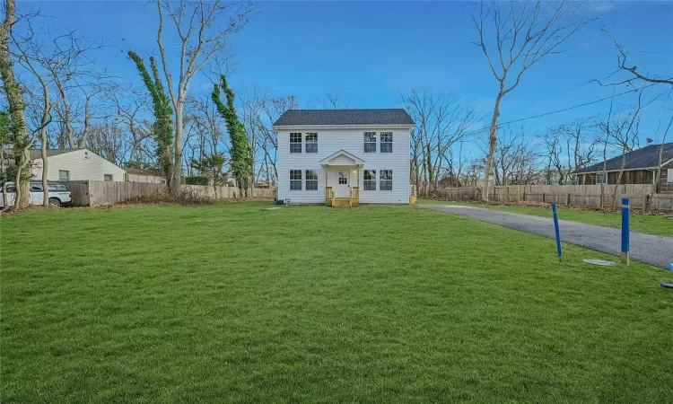 Colonial inspired home with a front yard. Grass is photoshopped & pictures show of the same home but located at a different address & size of property.