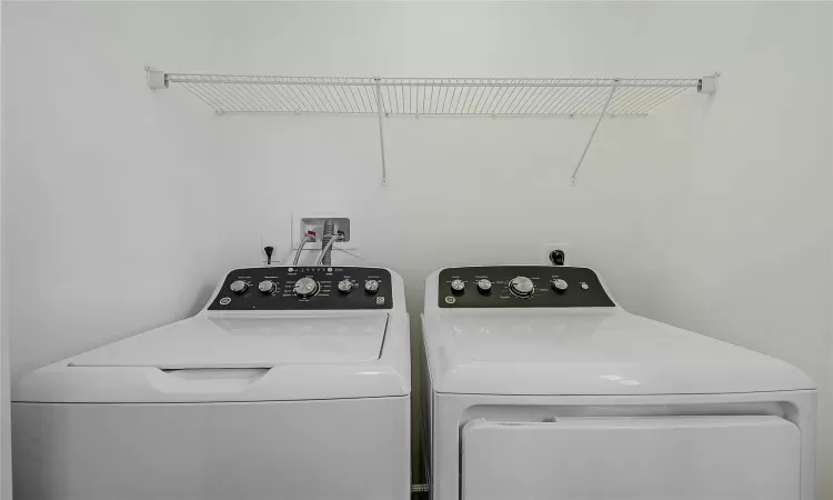 Laundry area located in the half bath on main floor with washer and dryer