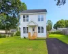 Colonial home featuring a front lawn~this picture is from a recent same model that sold