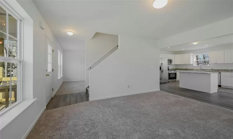 Living room looking towards kitchen & formal dining room.