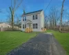 Colonial home with a side walk down entrance to full unfinished basement.