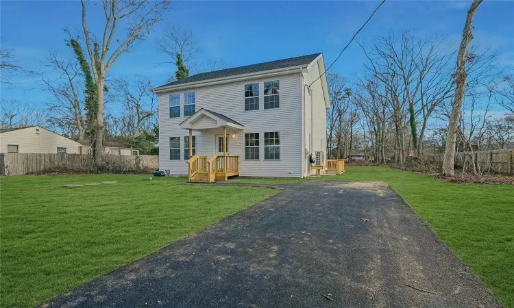 Colonial home with a side walk down entrance to full unfinished basement.