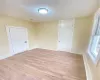 Unfurnished room with a textured ceiling and light wood-type flooring