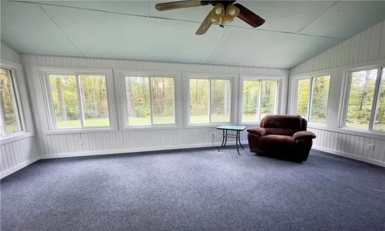 Sunroom / solarium with ceiling fan and lofted ceiling