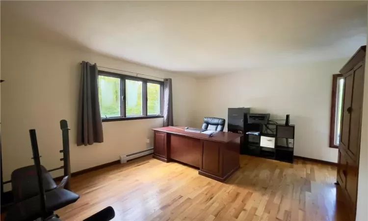 1st floor BR used as Office space featuring a baseboard radiator and light wood-type flooring