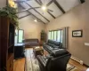 Living room with a wealth of natural light, ceiling fan, baseboard heating, and light wood-type flooring