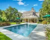 View of swimming pool with french doors and a patio area