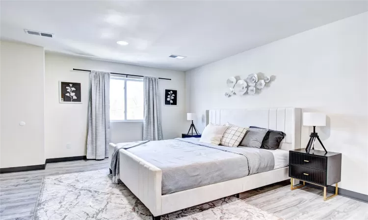 Bedroom with light hardwood / wood-style floors