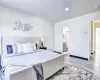 Bedroom featuring connected bathroom and light hardwood / wood-style floors