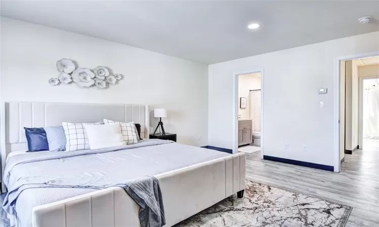 Bedroom featuring connected bathroom and light hardwood / wood-style floors