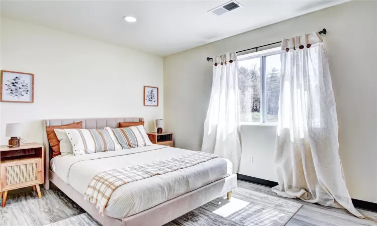 Bedroom with wood-type flooring