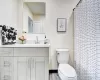 Bathroom featuring hardwood / wood-style floors, vanity, toilet, and walk in shower