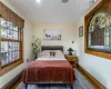 Kitchen with hardwood / wood-style floors, premium range hood, decorative light fixtures, backsplash, and an island with sink