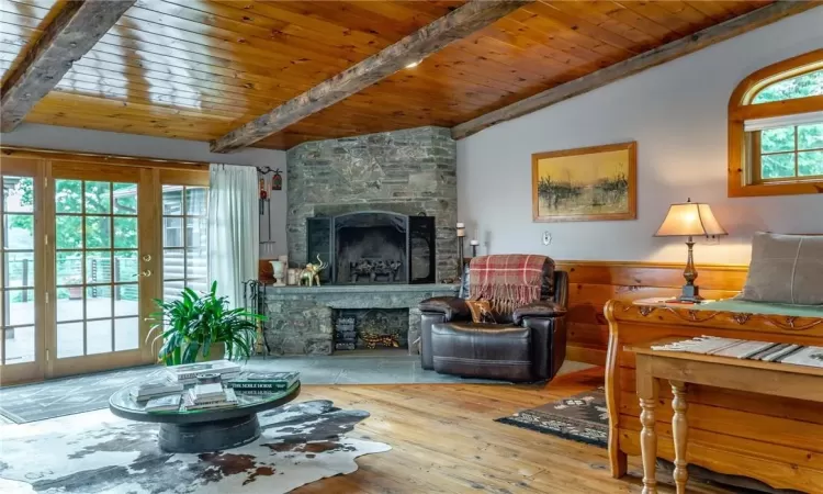 Living room featuring wooden ceiling, a fireplace, hardwood / wood-style flooring, and a chandelier