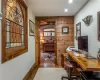 Kitchen featuring light wood-type flooring, premium range hood, built in appliances, a fireplace, and sink