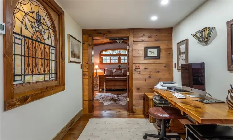 Kitchen featuring light wood-type flooring, premium range hood, built in appliances, a fireplace, and sink