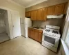 Kitchen featuring sink, white appliances, and ornamental molding