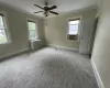 Empty room featuring a wealth of natural light, radiator heating unit, and ornamental molding