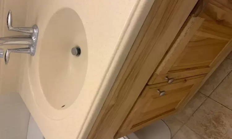 Bathroom featuring tile patterned flooring, vanity, and toilet