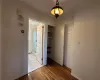 Hall featuring hardwood / wood-style flooring and crown molding