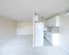 Kitchen with dishwasher, backsplash, white refrigerator, sink, and white cabinetry