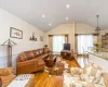 Living room with vaulted ceiling and light wood-type flooring