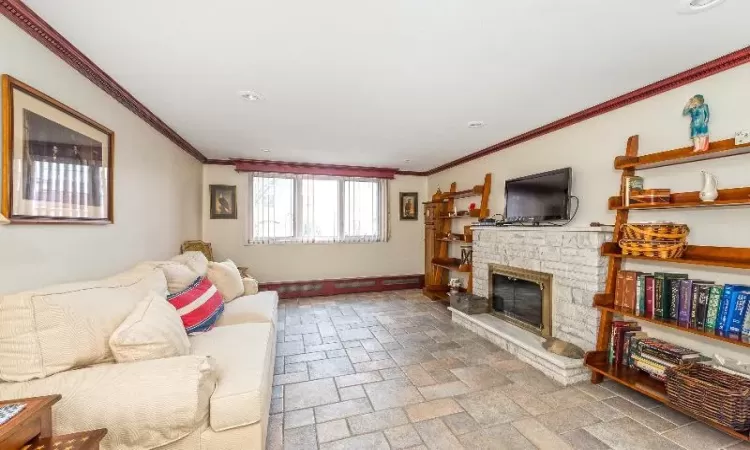 Living room with a fireplace and ornamental molding