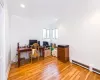 Office featuring crown molding, light hardwood / wood-style floors, and a baseboard heating unit