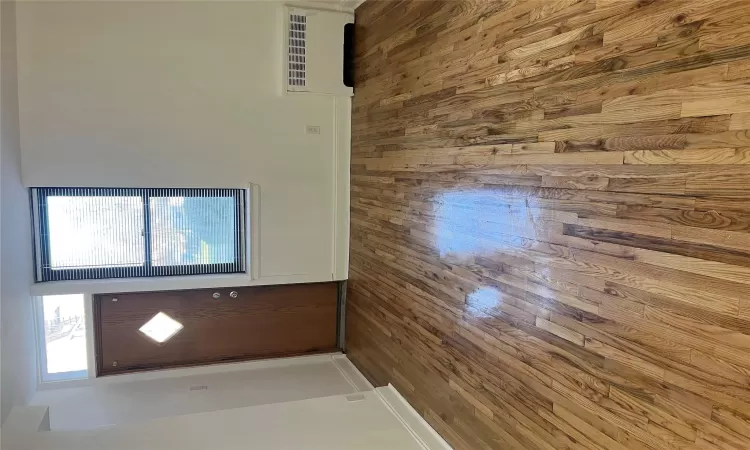 Entryway with hardwood / wood-style flooring and radiator