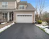 View of front of house featuring a garage and a lawn