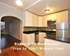 Kitchen with appliances with stainless steel finishes, dark hardwood / wood-style flooring, backsplash, sink, and white cabinets