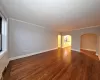 Empty room with crown molding and dark hardwood / wood-style flooring