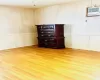 Primary Bedroom featuring wall ac unit and light hardwood  flooring