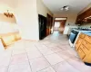 Kitchen featuring black fridge, a chandelier, decorative backsplash, light tile patterned floors, and white gas range oven