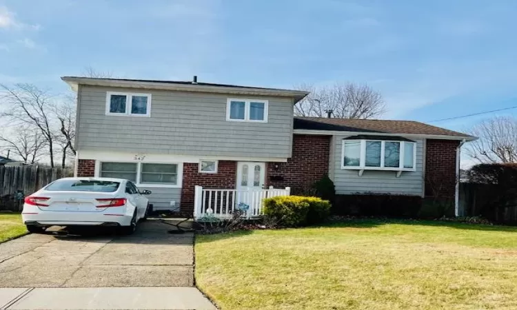 Split level home featuring a front lawn