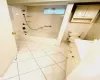 Full bathroom with vanity, tile walls, tile patterned flooring, toilet, and tiled shower / bath