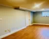 Basement with wood-type flooring and ornamental molding