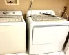 Laundry room featuring washing machine and dryer and light tile patterned floors