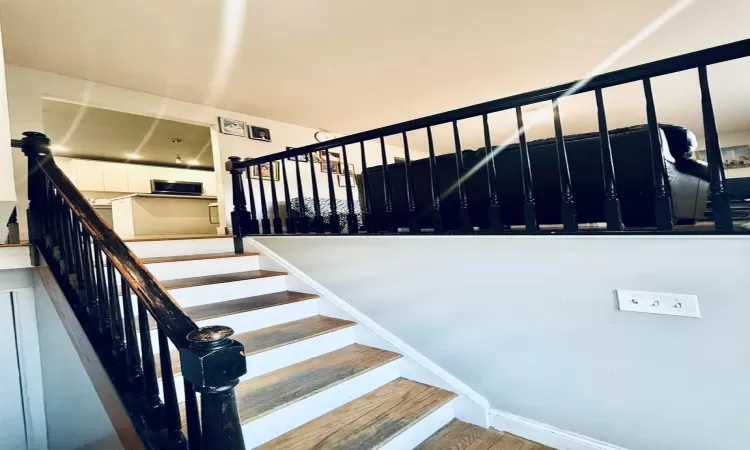 Stairway featuring wood-type flooring