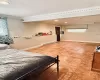 Bedroom featuring crown molding, tile patterned flooring, and a baseboard radiator