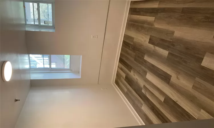 Empty room featuring dark hardwood / wood-style flooring