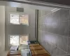 Kitchen featuring extractor fan, dark tile patterned flooring, baseboard heating, and plenty of natural light