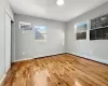 Unfurnished bedroom featuring baseboard heating and light hardwood / wood-style flooring