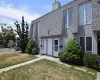 Rear view of house featuring a yard