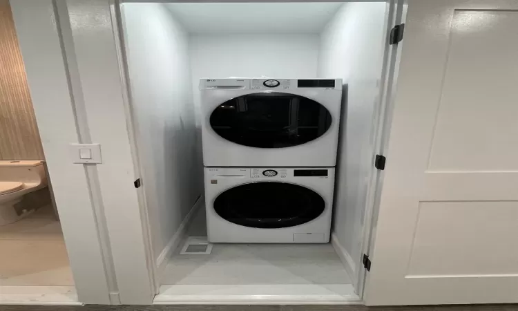 Washroom with stacked washer / dryer