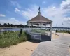 View of dock with a gazebo and a water view