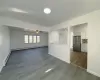 Kitchen featuring white cabinets, light hardwood / wood-style floors, a baseboard heating unit, and appliances with stainless steel finishes