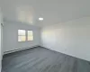 Empty room featuring a baseboard radiator and hardwood / wood-style flooring