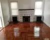 parquet floors, a brick fireplace, and radiator