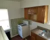 Kitchen with dark parquet floors, tile walls, white range with gas cooktop, and sink